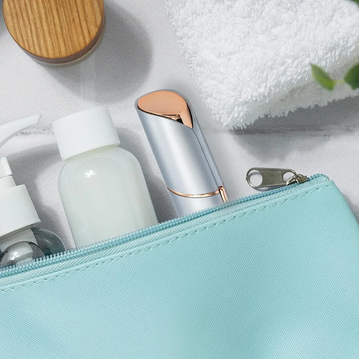 compact facial hair remover packed in a makeup bag