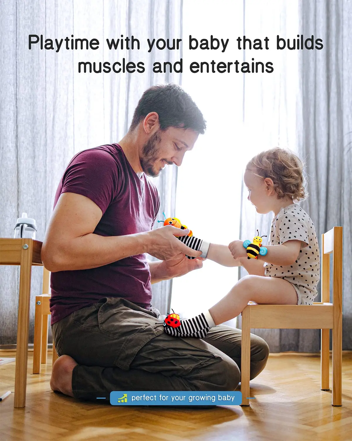 parent playing with baby wearing wrist rattles