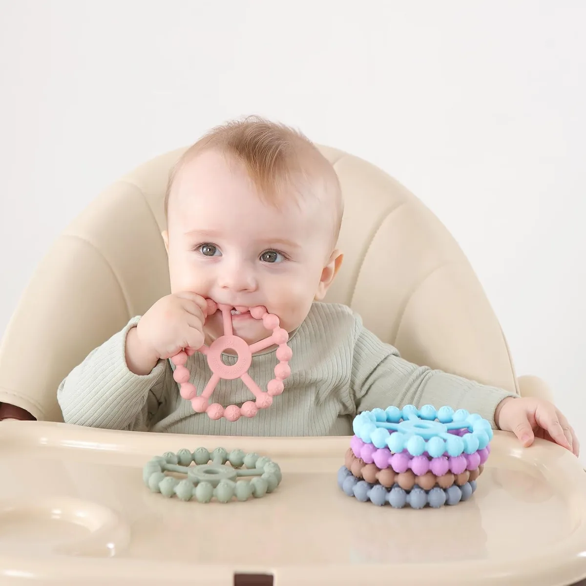 baby chewing a silicone ring teether
