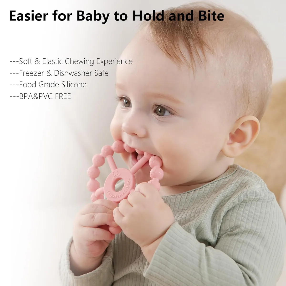 baby holding a silicone ring teether easily