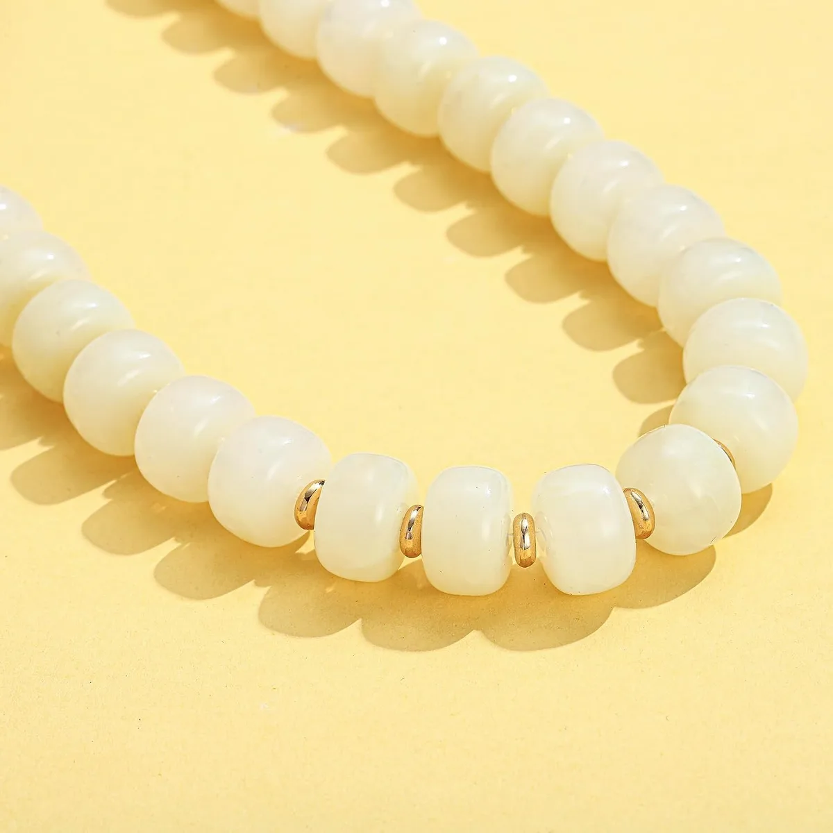 glossy white beads of the chunky necklace