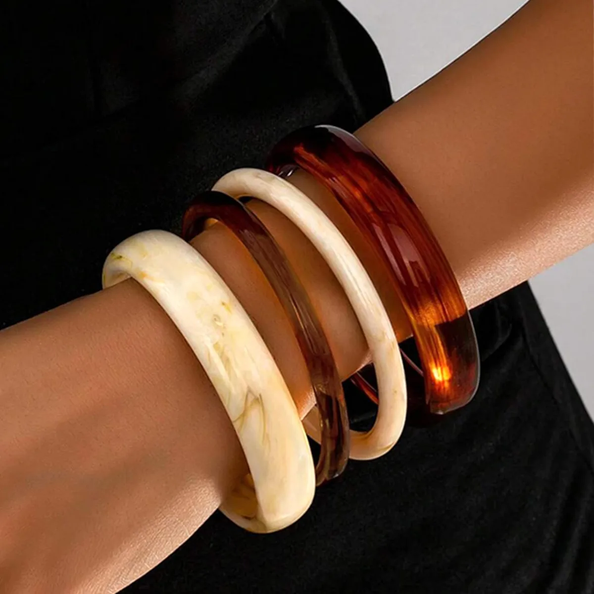 chunky resin bangles stacked on the wrist