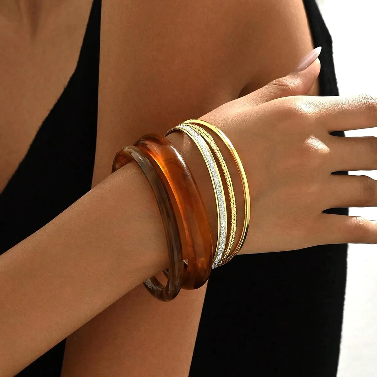resin bangles worn with a sweater
