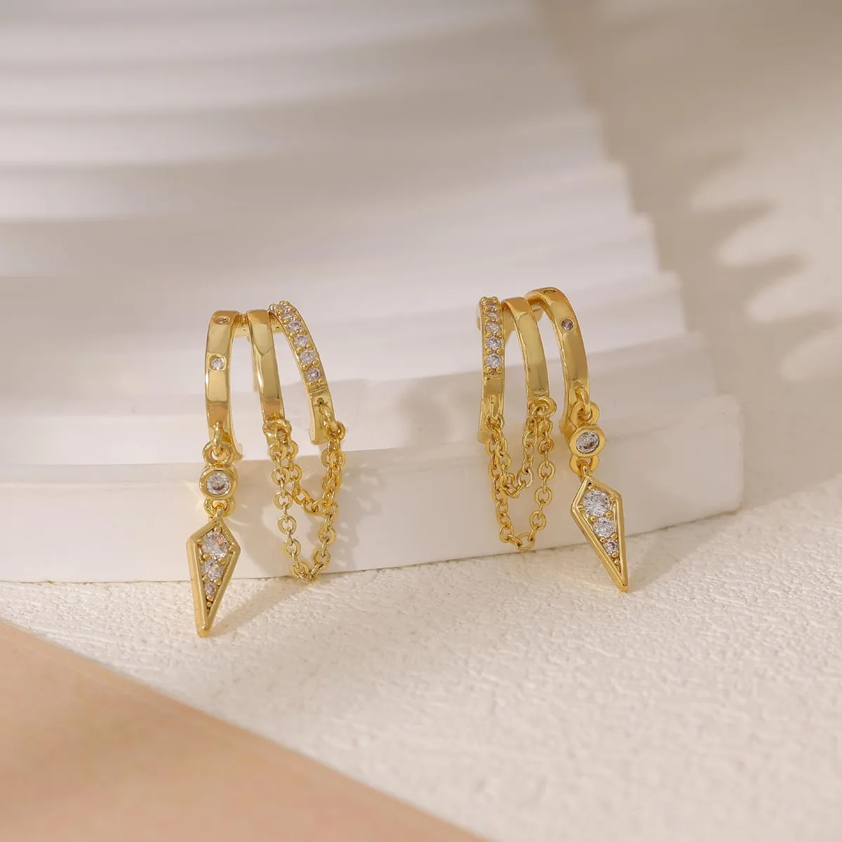 gold dangle huggie earrings close-up